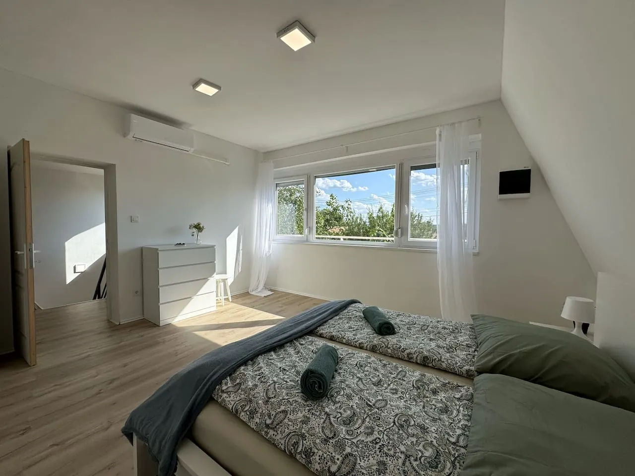 Bright attic bedroom in a professionally managed premium holiday house in Balatonszabadi, Hungary