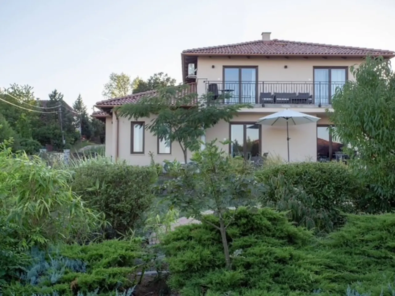 Garden façade and balcony terrace of a professionally managed premium villa in Balatonalmádi, Hungary
